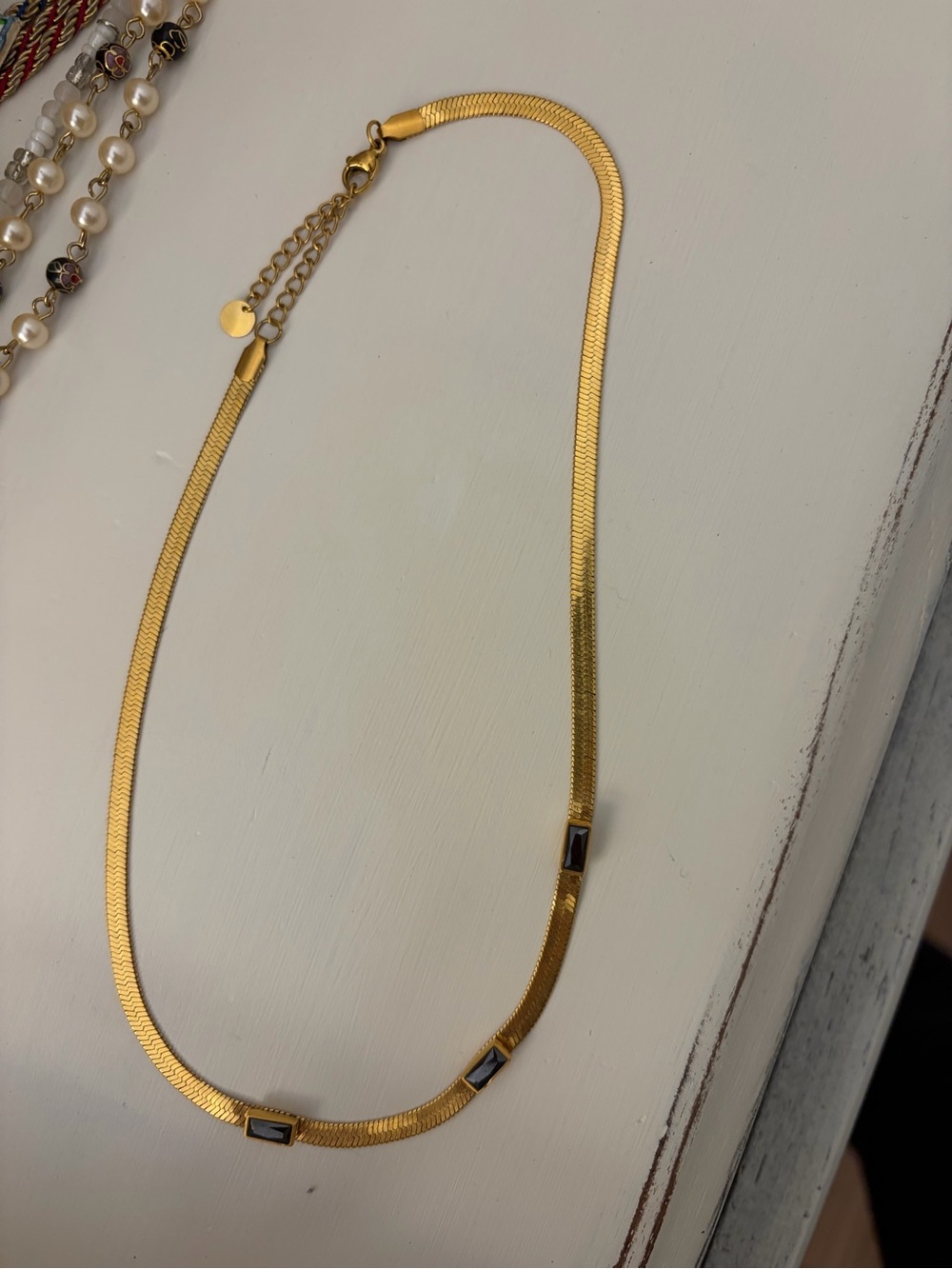 Gold Tone Herringbone Necklace with Black Stone Accents